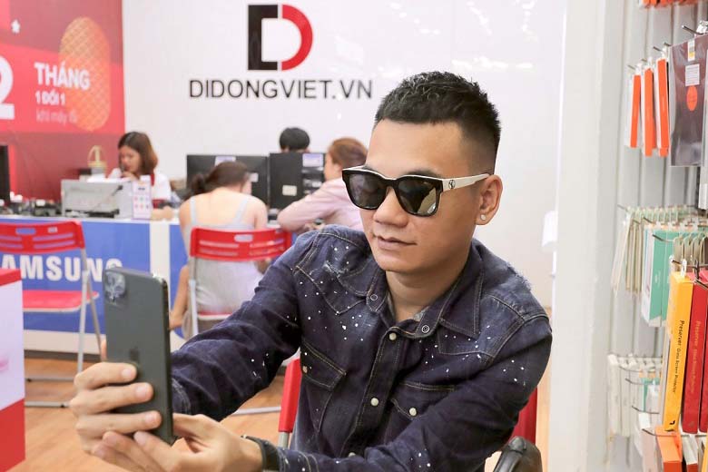 Ca sĩ Khắc Việt đang trải nghiệm tính năng camera selfie của điện thoại
